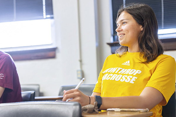 a student smiling in a classroom