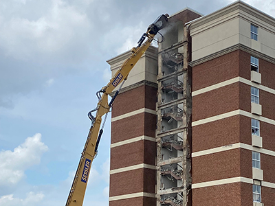 Crane tearing down bricks from Wofford Hall