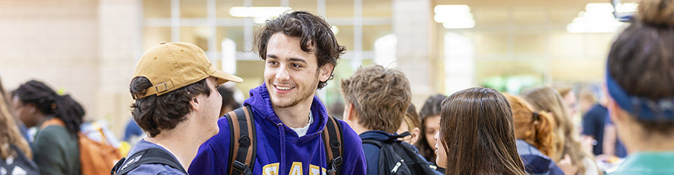 A group of students interacting at a booth during an event