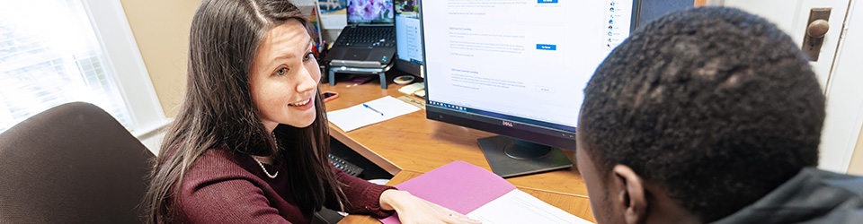 a financial aid employee going over options with a student