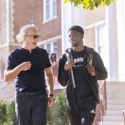 Faculty and student are seen walking out of Thurmond Hall