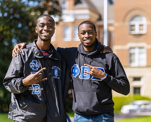 two fraternity brothers smiling at the camera