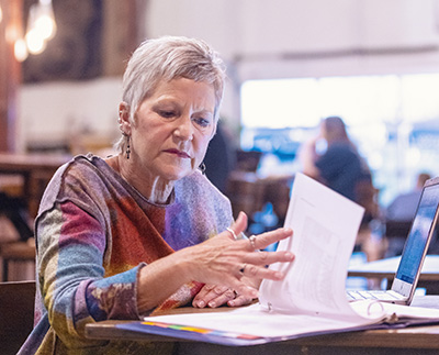 a senior citizen studying a textbook