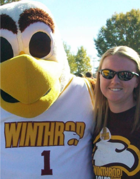 Woman posing with Big Stuff mascot