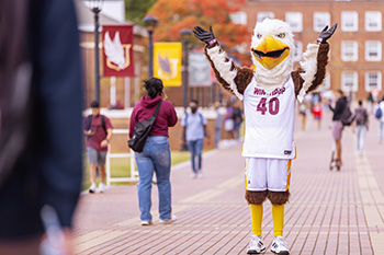 Winthrop's mascot Big Stuff standing with arms up on Scholars Walk