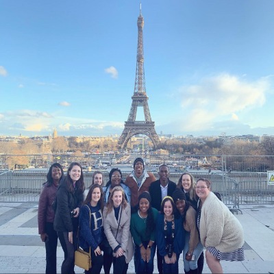 Close Scholars in front of the Eiffel Tower